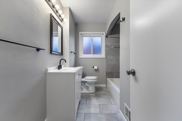 full bathroom with tiled shower / bath combo, vanity, tile patterned floors, and toilet