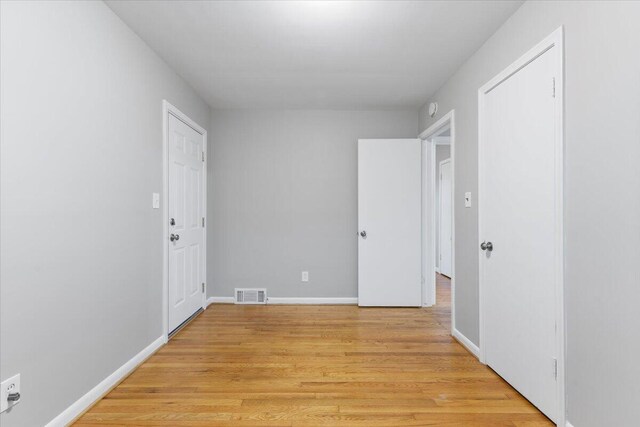 spare room with light wood-type flooring