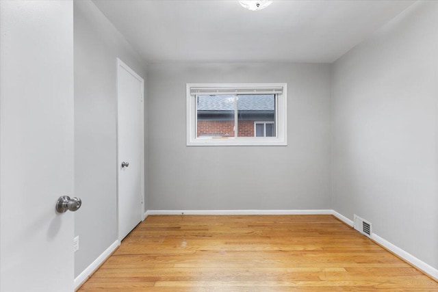 spare room featuring light hardwood / wood-style flooring