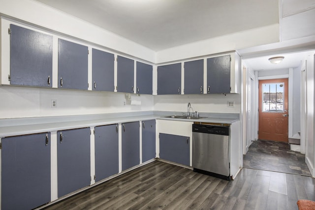 kitchen with dark hardwood / wood-style flooring, sink, stainless steel dishwasher, and blue cabinetry