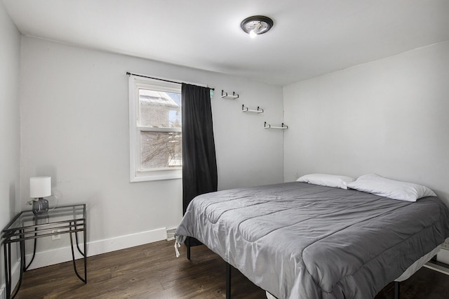 bedroom with dark hardwood / wood-style flooring