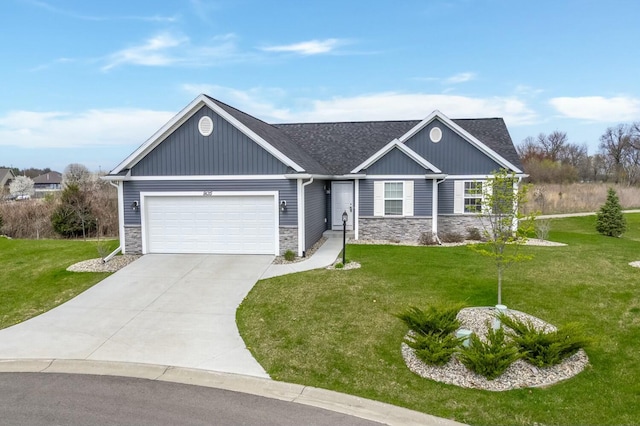 view of front of home with driveway, stone siding, roof with shingles, a front yard, and a garage