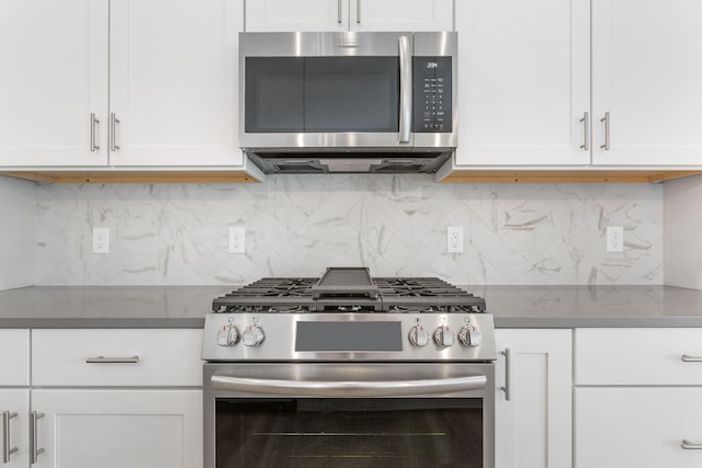 kitchen featuring backsplash, stainless steel appliances, and white cabinets