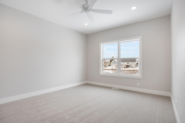 carpeted spare room with ceiling fan