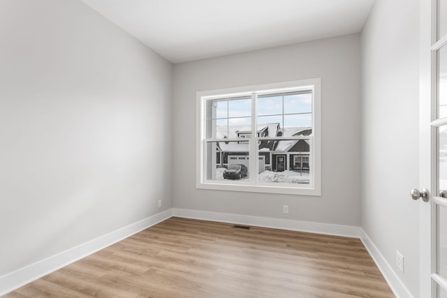 unfurnished room with light hardwood / wood-style floors