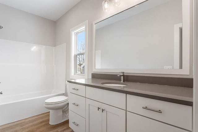 full bathroom featuring shower / tub combination, wood-type flooring, vanity, and toilet