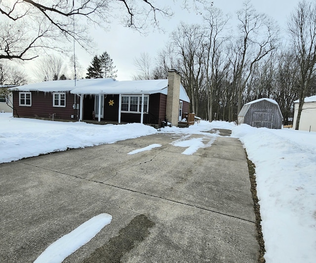 view of front of home featuring a shed