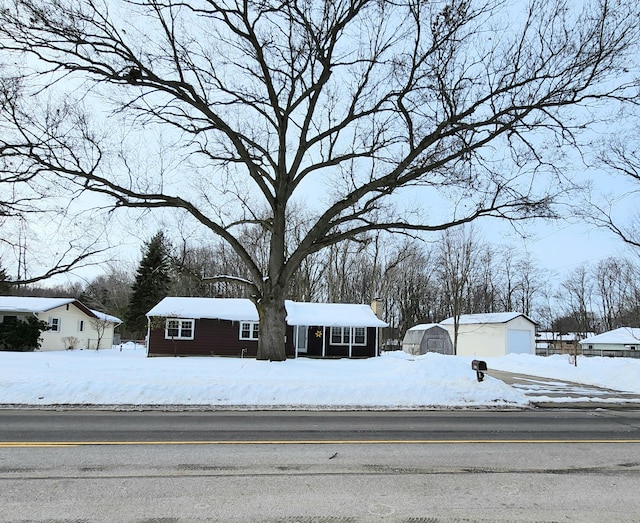 view of front facade with a garage and an outbuilding