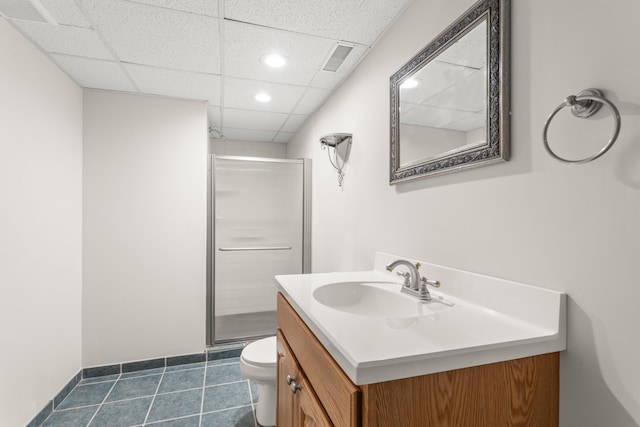 bathroom featuring vanity, a shower with shower door, a paneled ceiling, and toilet