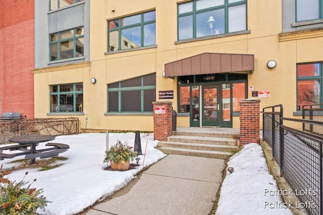 view of snow covered property entrance