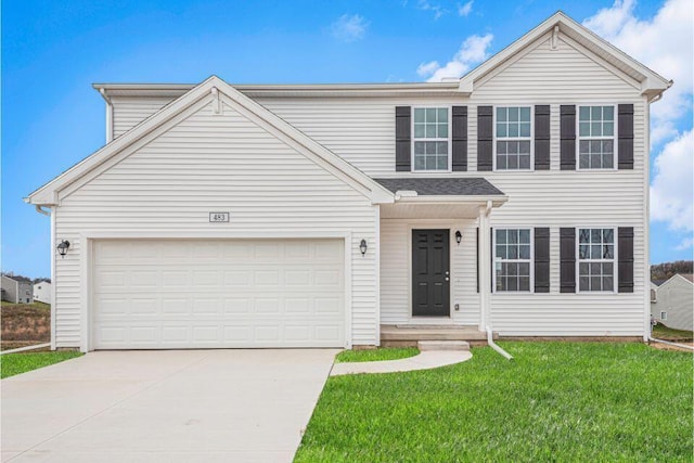 view of front of property with a garage and a front yard