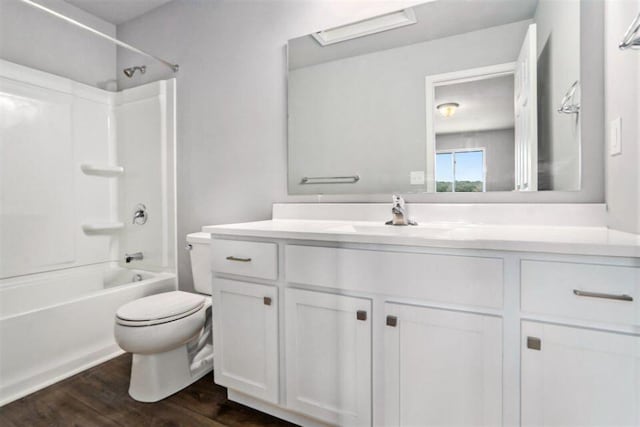 full bathroom featuring hardwood / wood-style flooring, shower / bathtub combination, vanity, and toilet