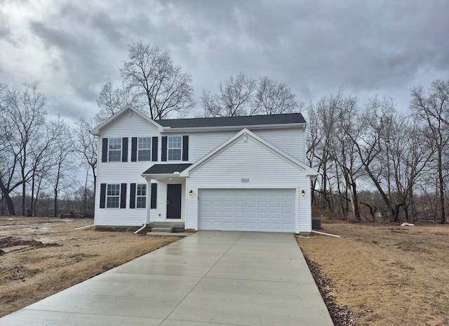 traditional-style house featuring a garage and concrete driveway