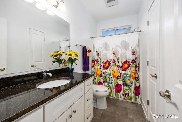 bathroom featuring vanity, toilet, and a shower with shower curtain