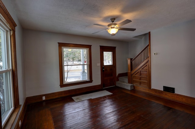 entrance foyer featuring ceiling fan, hardwood / wood-style floors, and a textured ceiling