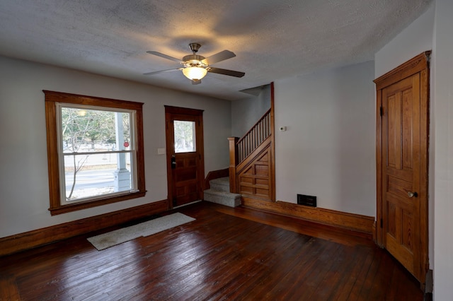 foyer featuring hardwood / wood-style floors, a textured ceiling, and ceiling fan