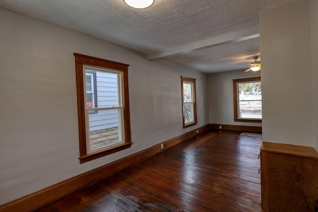 unfurnished room featuring a textured ceiling and dark hardwood / wood-style flooring