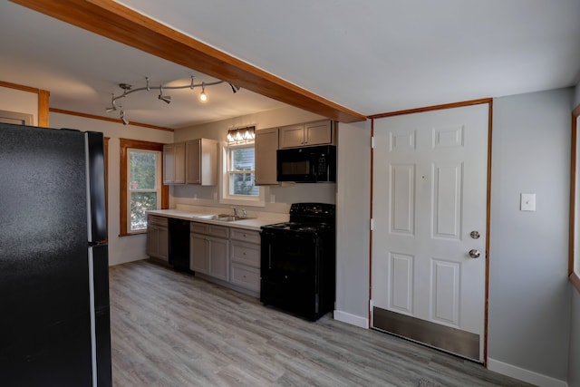 kitchen with gray cabinets, sink, light hardwood / wood-style flooring, and black appliances