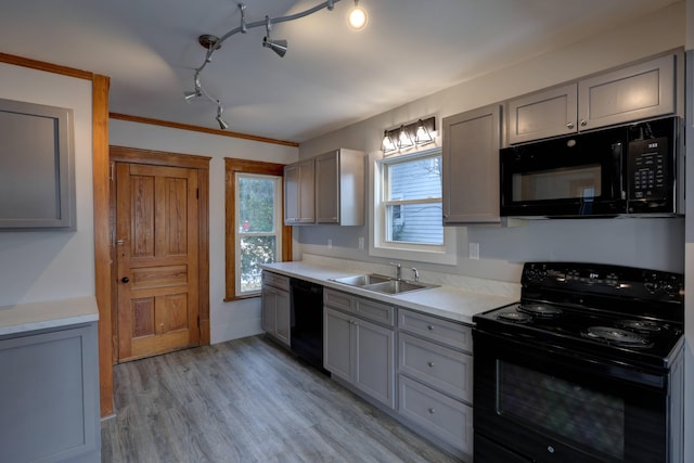 kitchen featuring sink, gray cabinets, black appliances, light hardwood / wood-style floors, and ornamental molding