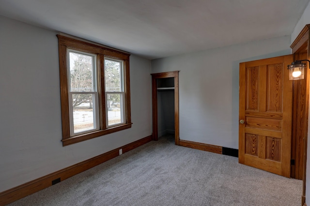 unfurnished bedroom with carpet floors and a closet