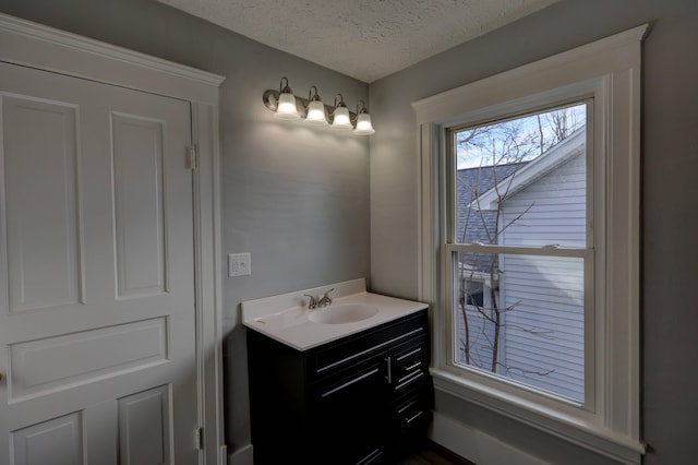 bathroom with vanity and a textured ceiling