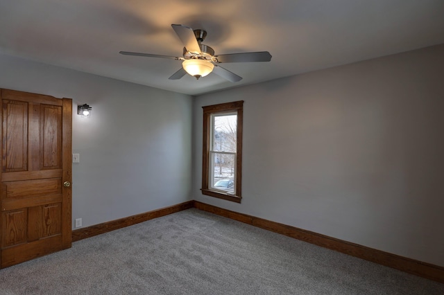 carpeted spare room with ceiling fan