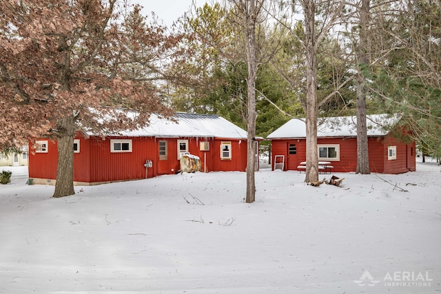 view of snow covered back of property