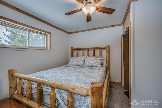 carpeted bedroom featuring crown molding and ceiling fan