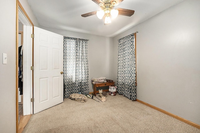 interior space featuring carpet and ceiling fan