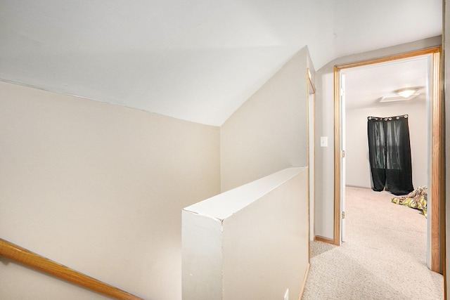 hall with light colored carpet and lofted ceiling