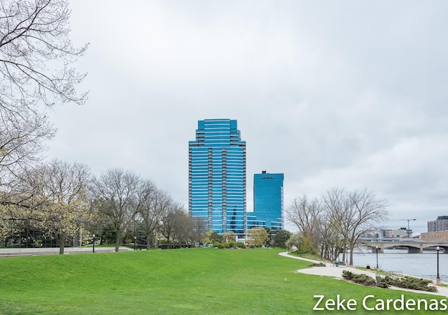 view of community featuring a lawn and a water view