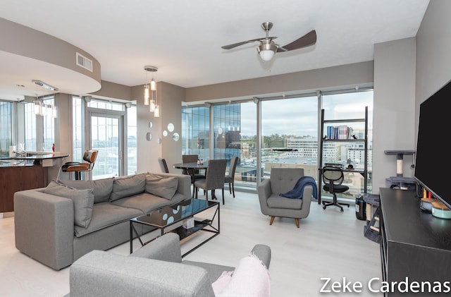 living room featuring plenty of natural light and ceiling fan