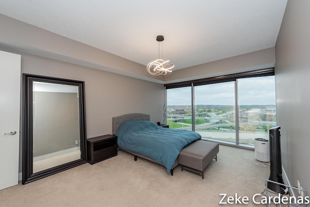 bedroom featuring light carpet and a notable chandelier