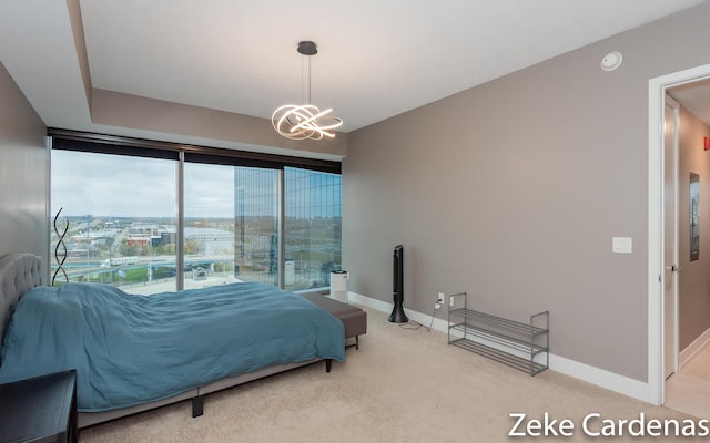 bedroom with multiple windows, a chandelier, and carpet