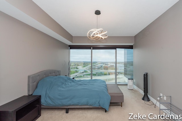 bedroom with carpet flooring and a notable chandelier