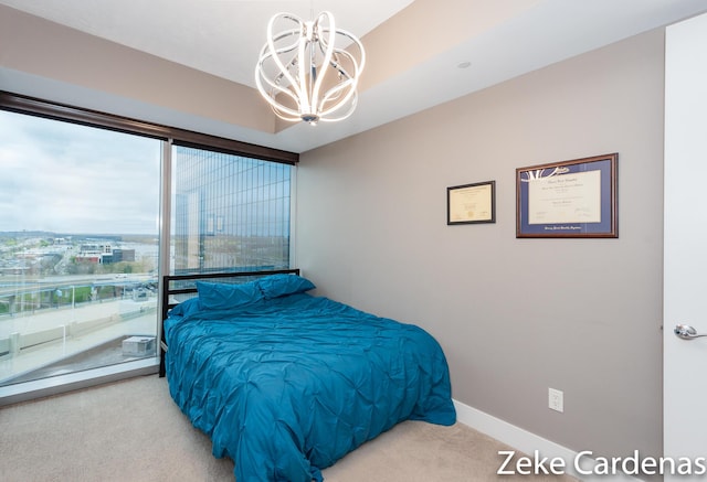 carpeted bedroom featuring a notable chandelier