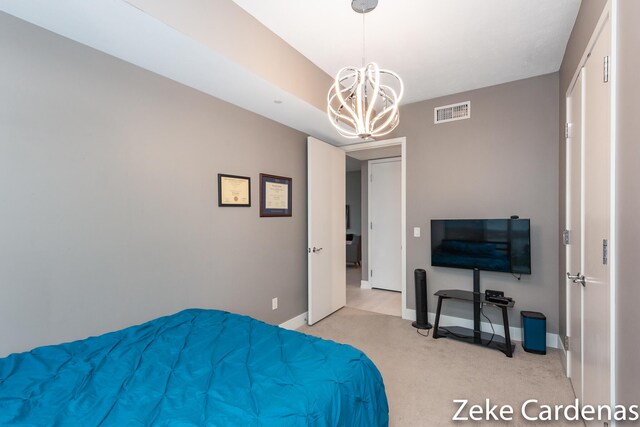 carpeted bedroom featuring a chandelier