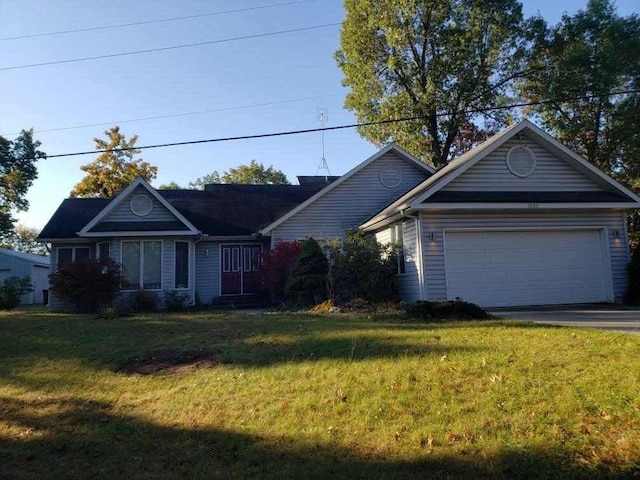 ranch-style home with a garage and a front lawn