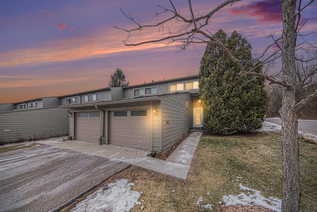 view of garage at dusk