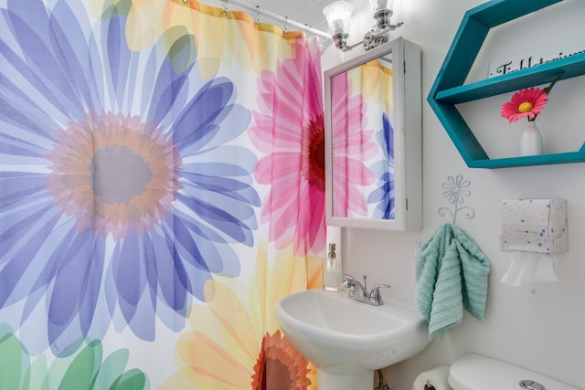 bathroom featuring sink and toilet