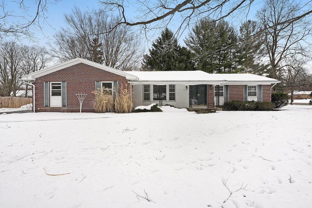 view of snow covered rear of property