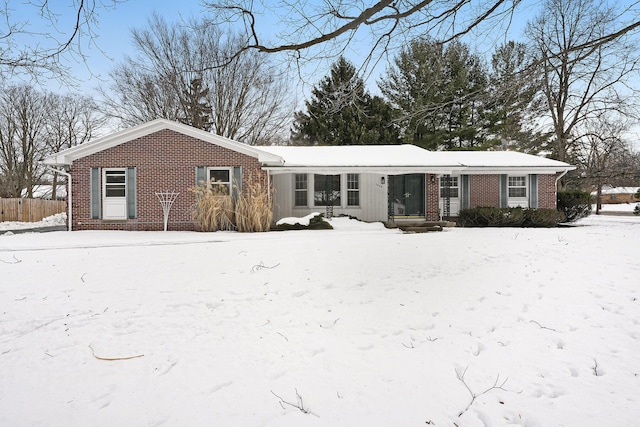 view of snow covered rear of property