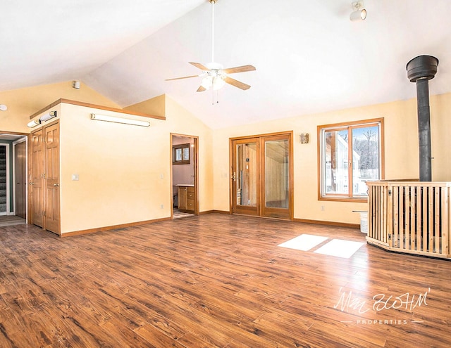 unfurnished living room with hardwood / wood-style floors, high vaulted ceiling, and ceiling fan