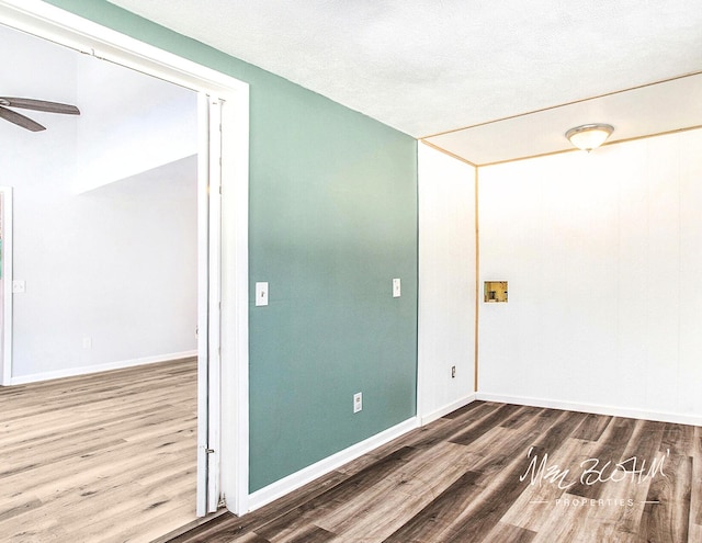 spare room with ceiling fan, hardwood / wood-style floors, and a textured ceiling