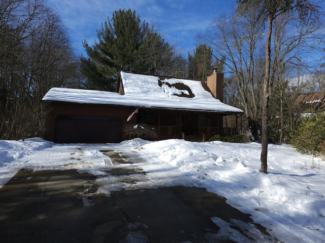 snow covered property with a porch