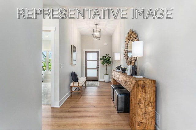 entrance foyer featuring a notable chandelier and light hardwood / wood-style floors