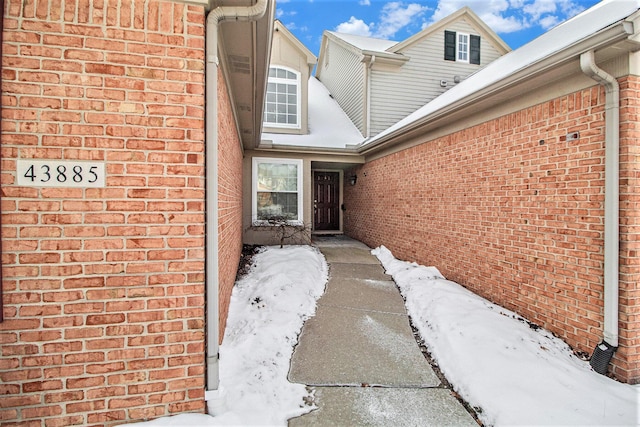 view of snow covered property entrance