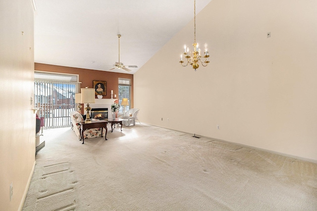 dining space featuring ceiling fan with notable chandelier, carpet flooring, and high vaulted ceiling