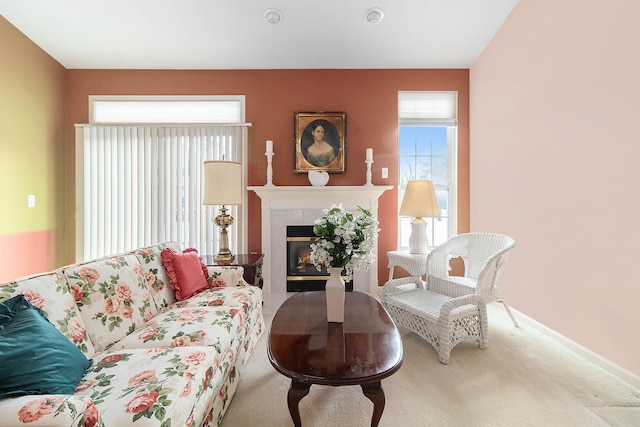 living room with carpet flooring and a tiled fireplace