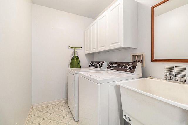 laundry area with cabinets, independent washer and dryer, and sink